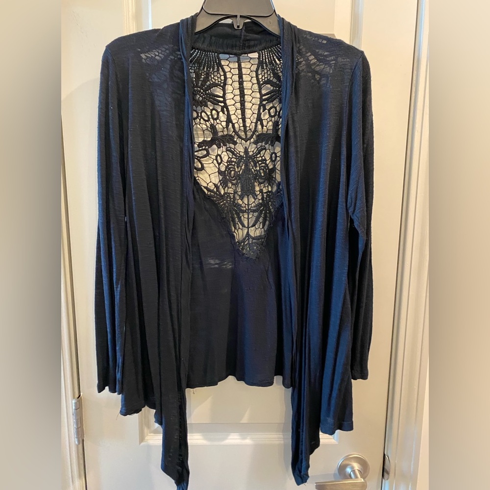 He’s there’d black cardigan with design on the back